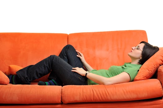 happy young woman relax on orange sofa photo