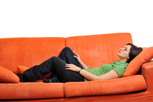 happy young woman relax on orange sofa photo