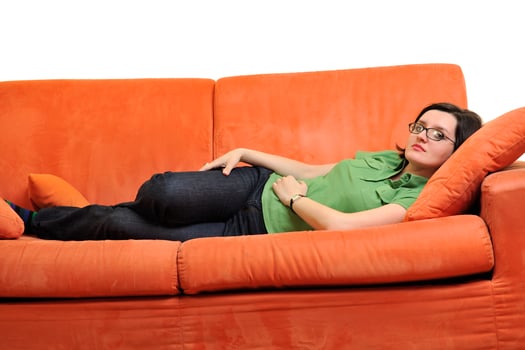 happy young woman relax on orange sofa photo