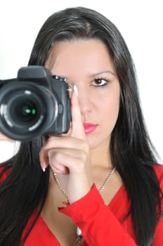 Young woman holding camera in hand taking picture isolated photo