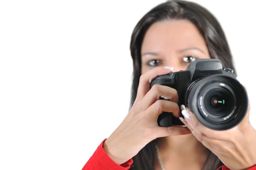 Young woman holding camera in hand taking picture isolated photo