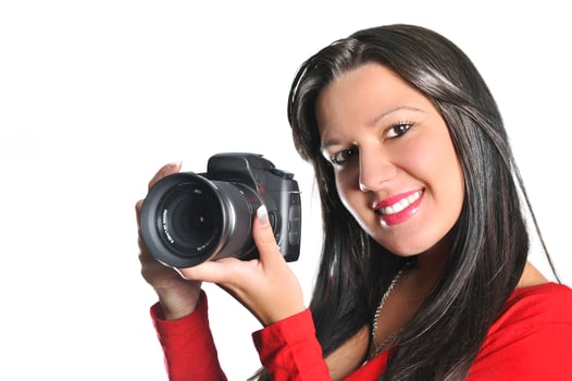 Young woman holding camera in hand taking picture isolated photo