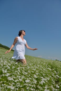 Young happy woman in green field photo