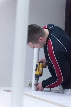 repairman working with drilling machine photo