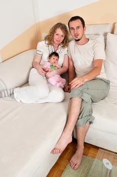 indoor portrait with happy young family and  cute little babby photo