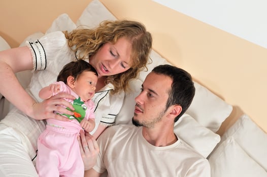 indoor portrait with happy young family and  cute little babby photo