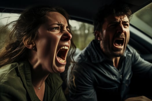 A close-up of two frustrated drivers one male and one female yelling at each other through car windows photo