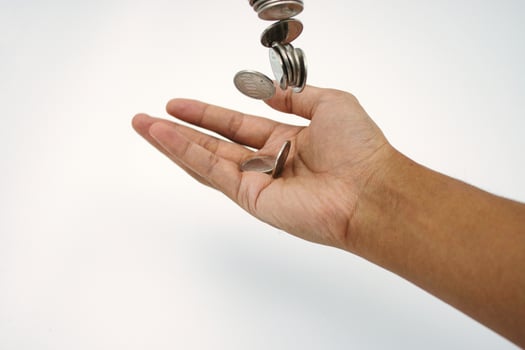 Small salary. Hand holding and receiving coin money on white background photo