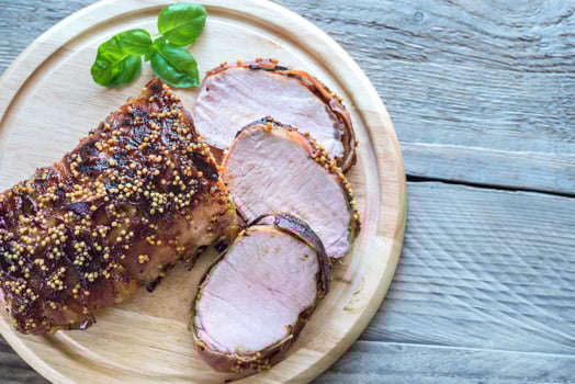 Baked pork meat wrapped in bacon photo