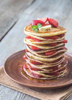 Stack of pancakes with fresh strawberries photo