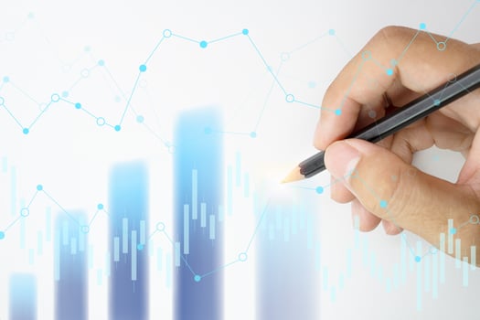 Hand holding pencil points to the graph analysis on monitor screen, Economic and financial concept, Business concept - Financial graphs drawn with pencil. photo