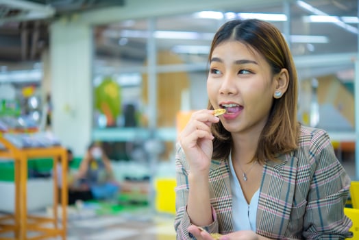Beautiful asian young beautiful business woman acting to eat whi photo