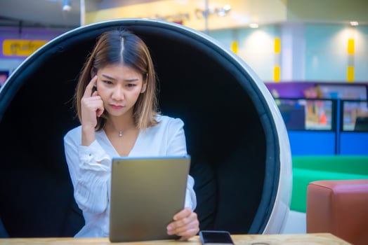 The thoughtful gesture of the Asian business woman emphasizes the importance of taking a data-driven approach to digital marketing. photo