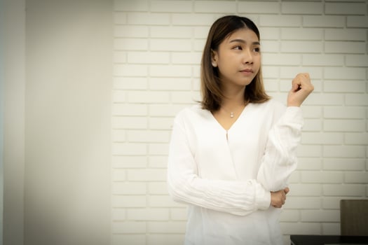 Portrait of a beautiful business woman is standing with a doubtful expression. photo