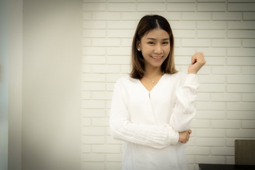 Beautiful asian female teacher is standing and looking at the camera with smile on her face. photo