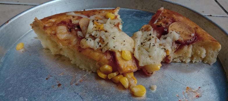 Corn pizza slice with cheese and sausage photo