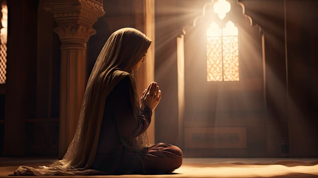 young muslim woman praying ,Young muslim woman praying in mosque photo