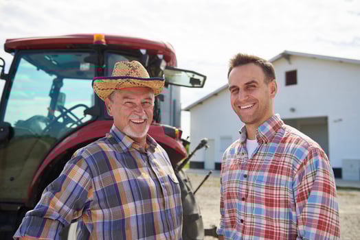 Portrait of two farmers in front of the barn photo