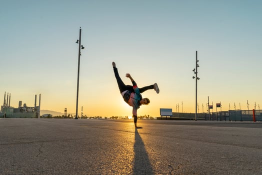 Acrobat doing handstand in the city at sunrise photo