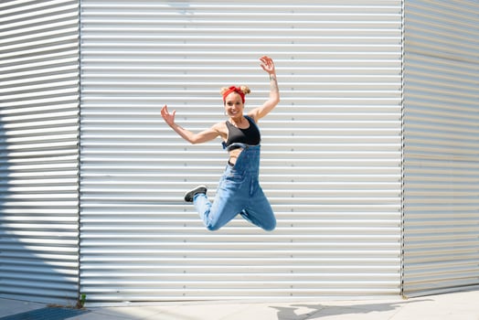 Smiling young woman jumping in the air photo