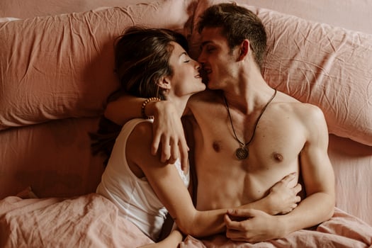 Intimate young couple lying in bed photo