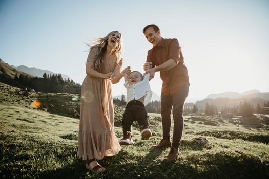 Happy family playing with little son on a hiking trip, Schwaegalp, Nesslau, Switzerland photo