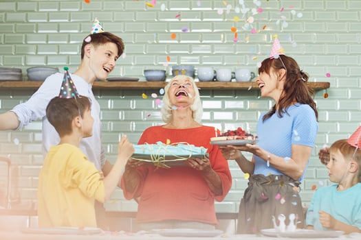 Mother and sons celebrating grandmother's bithday in their kitchen photo