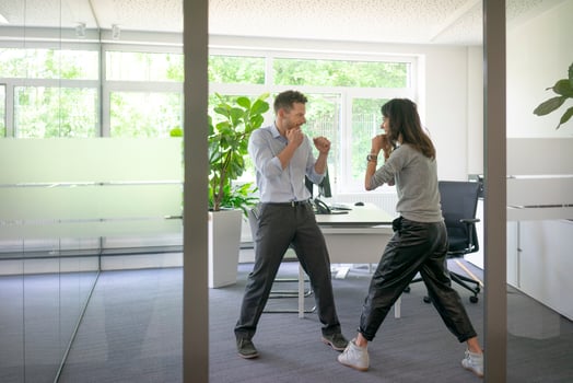 Businessman and businesswoman fighting in office photo