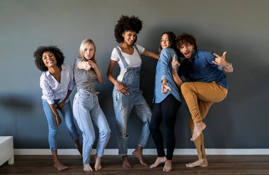 Group portrait of friends standing at a wall posing photo