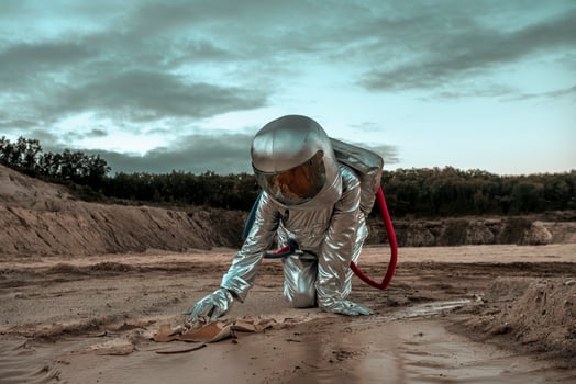 Spaceman exploring nameless planet, searching the soil photo