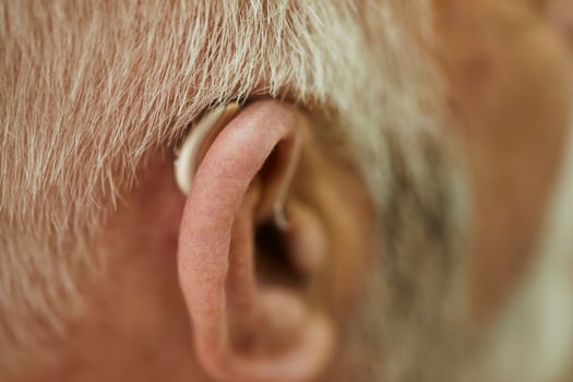Close-up of senior man with hearing aid photo