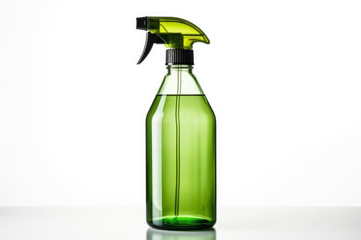 Simple glass spray bottle with natural cleaning solution isolated on a white background photo