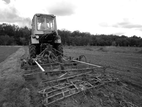 Plowed field by tractor in black soil on open countryside nature photo