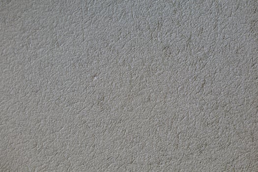 background old concrete wall that shows signs of cracking and deterioration from weather and age. Concrete backgrounds with natural textures are great for designs and include Copy Space backgrounds photo