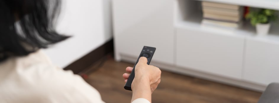 Elderly woman Watching smart TV and using remote controller Hand holding television audio remote control Middle age Asian woman movie Television series spending time at home photo