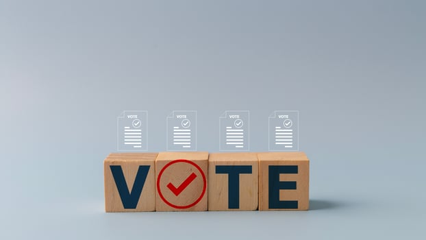 Political election campaign logo. Election invitation campaign for the right to vote. Election voting concept. Vote words with checkmark symbols on wooden cube blocks.  Elections and poll icons. photo