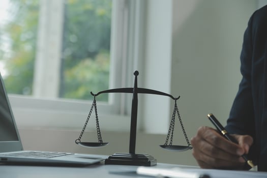 Business and lawyers discussing contract papers with brass scale on desk in office. Law, legal services, advice, justice and law concept picture with film grain effect photo