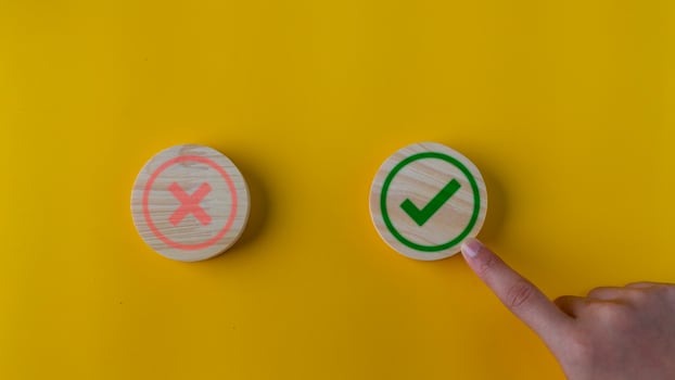 Right and wrong or voting yes or no concept. Wooden blocks with check marks on a yellow background. The idea of choice. photo