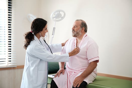 Female doctors in uniform healthy check White male patients in examination coat by stethoscope, and checkups and advise health care diagnosis at clinic hospital, and appointments visit. photo