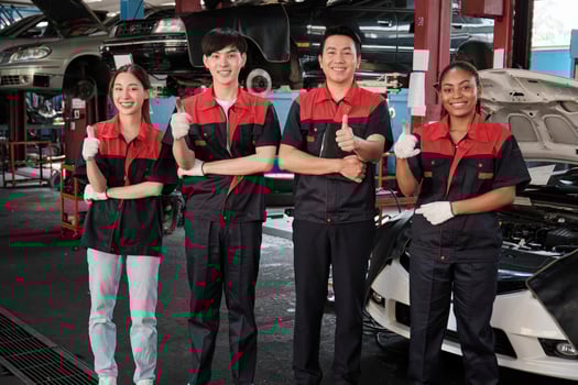 Portrait of multiracial professional mechanic team thumbs up and look at camera, work at car service garage, happy maintenance jobs, check and repair occupation in automotive industry business. photo