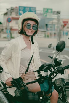 asian woman wearing safety helmet sitting on motorcycle,color process by japanese style photo