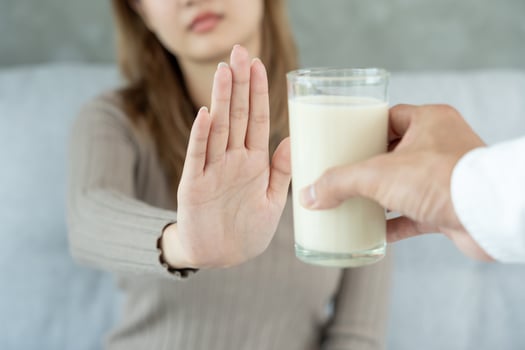 Milk allergens, Sick sad unhealthy, woman confuse drink milk, runny stuffy sore nose suffer from intolerance allergy trigger symptoms. abdominal pain, allergens, protein, rash, death, food allergy photo