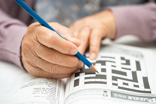Alzheimer disease AD, Asian elderly woman playing sudoku puzzle game to practice brain training for dementia prevention. photo