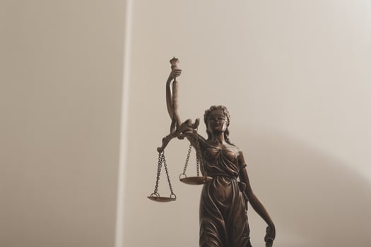 Business and lawyers discussing contract papers with brass scale on desk in office. Law, legal services, advice, justice and law concept picture with film grain effect photo