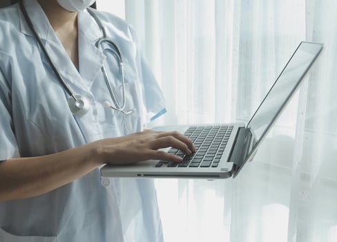 Doctor working with laptop computer in medical workspace office. doctor working on laptop computer in modern clinics office. search medical information. banner copy space photo