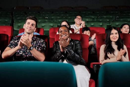Various people in theater. Multiracial audiences, Black woman, and friends enjoy watching cinema and applauding together on movie shows, entertainment lifestyle with film, happy and cheerful smiles. photo
