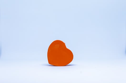 Orange heart on white background photo