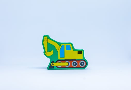 Yellow excavator on white background photo