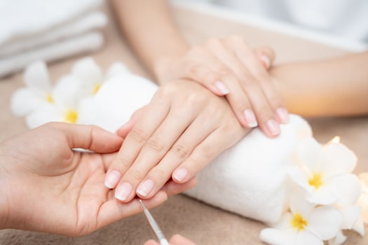Woman receive care service by professional Beautician Manicure at spa centre. Nail beauty salon use nail file for Glazing treatment. manicurist make nail customer to beautiful. body care spa treatment photo