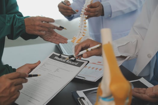 Group of doctors reading a document in meeting room at hospital photo